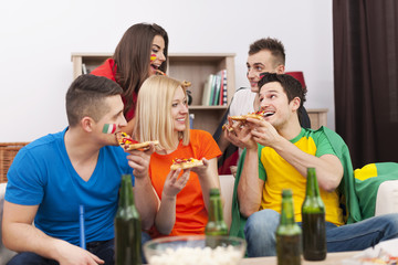 Group of multinational people eating pizza