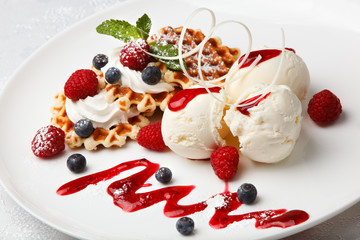 Vanilla ice cream and waffles with fresh berries