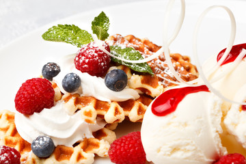 Waffle with vanilla ice cream and fresh berries
