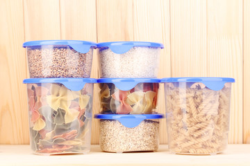 Filled plastic containers on wooden background