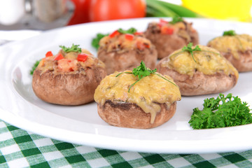 Stuffed mushrooms on plate on table close-up