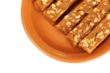 Cut sherbet with nuts in the plate on white background close-up