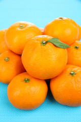 Ripe sweet tangerines, on color background