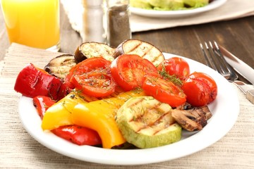 Delicious grilled vegetables on plate on table close-up