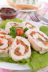 Delicious chicken roll on plate on table close-up