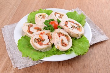 Delicious chicken roll on plate on table close-up