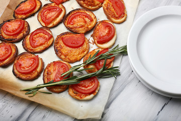 Small pizzas on baking paper close up