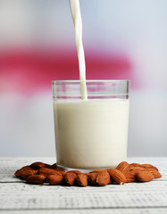 Almond milk is poured into glass,