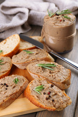 Fresh pate with bread on wooden table