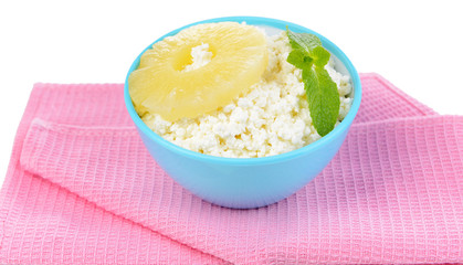Bowl of tasty cottage cheese with pineapple, isolated on white
