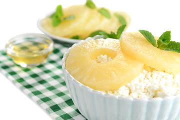 Bowl of tasty cottage cheese with pineapple, close up