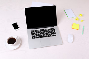 Office workplace with open laptop on wooden desk