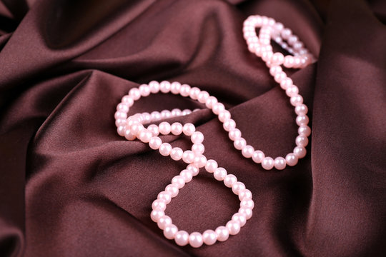 Beautiful pearls on brown silk cloth