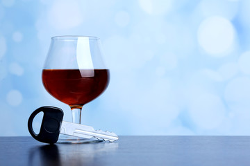 Composition with car key and glass of cognac,