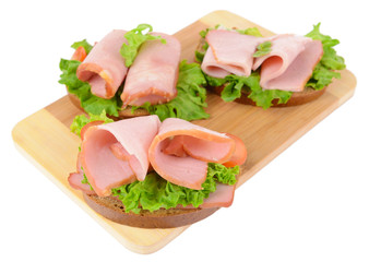 Delicious sandwiches with lettuce and ham isolated on white