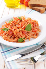 Pasta with tomato sauce on plate on table close-up