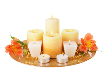 Beautiful candles with flowers isolated on white