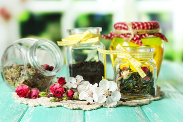 Assortment of herbs, honey and tea in glass jars