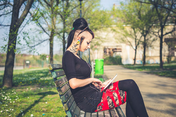 young beautiful punk dark girl using tablet