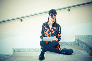 young beautiful punk dark girl using tablet