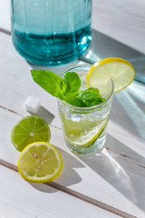 Cold drink with ice, citrus fruits and mint leaf