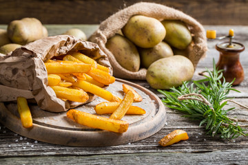 Fresh homemade fries with salt served in paper