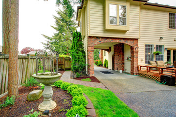 House with brick archway. View of antique fountain