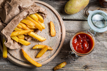 Homemade fries with ketchup and salt