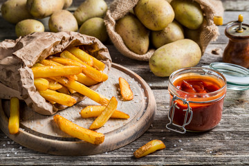 Closeup of homemade fries with ketchup and salt