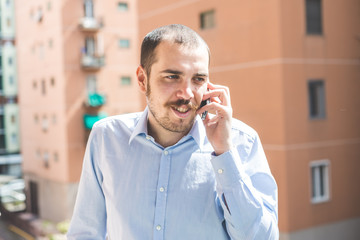 elegant business multitasking multimedia man calling with smartp