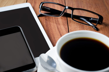 empty tablet and a cup of coffee