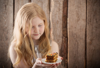 smile girl with cake on wooden background