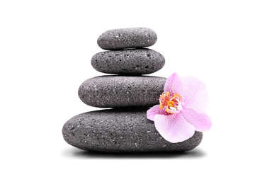 Fototapeta na wymiar Stack of balanced stones and an orchid