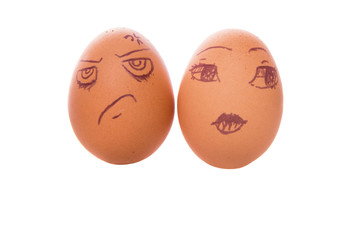 Drawn face expressions on chicken eggs