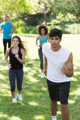 Fototapeta na wymiar Athletes jogging on grassy land