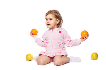 little girl with oranges