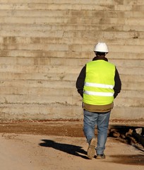worker with the yellow high-visibility jacket