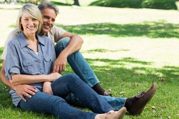 Happy couple sitting in park