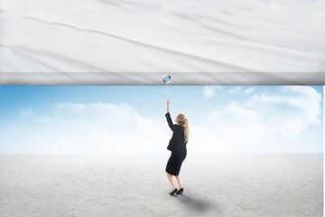 Fototapeta na wymiar Composite image of businesswoman pulling a white screen