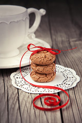 Cup of tea and cookies on wooden background