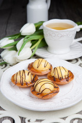 Sweet cake with cup of tea on wooden table