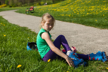 	girl on inline skates learns to ride 