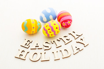 Colourful Painted easter egg with wooden text