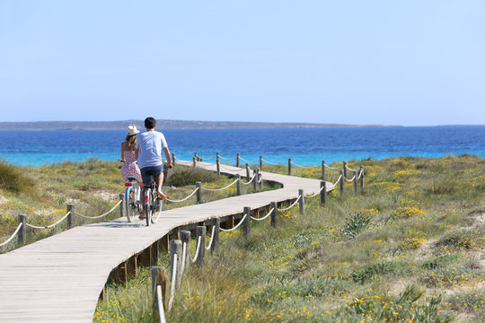 Couple riding bikes on Formentera Island