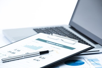 Businessman analyzing investment charts on laptop