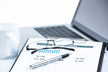 Businessman analyzing investment charts on laptop