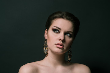 beauty portrait of girl with green eyes, big earrings