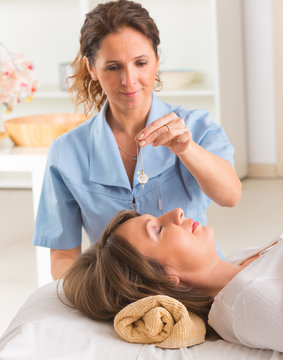 Therapist using pendulum