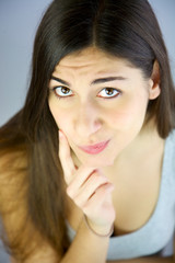 Fototapeta premium Young woman thinking not able to find solution to problem