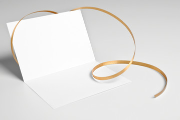 Blank open card with golden ribbon